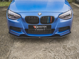 A blue BMW car front displays a black grille with colorful stripes; 