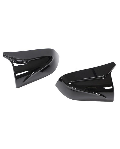 Black, glossy side mirror covers rest on a white background, angled stylishly. They feature sleek, aerodynamic curves, reflecting minimal ambient light.
