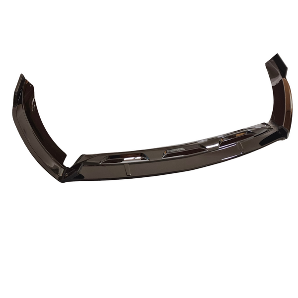 A glossy black car bumper, featuring aerodynamic contours and vent-like cutouts, rests on a plain white background.