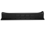 A black, elongated car running board features rectangular grooves along its surface, likely designed for traction. The background is plain white, emphasizing the running board's shape and texture.