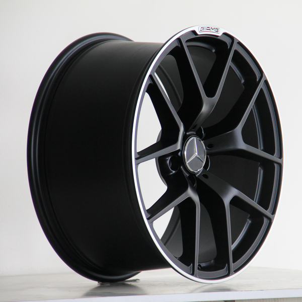 A black alloy wheel features a multi-spoke design with a Mercedes emblem at the center, placed against a simple white background.