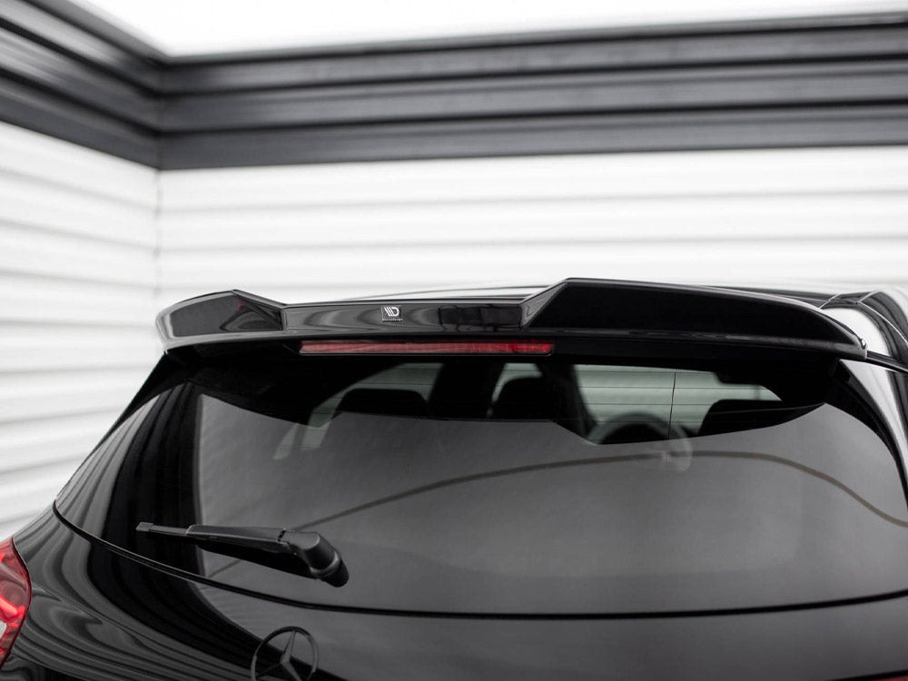 Car with rear spoiler, parked indoors; features a reflective black surface and rear wiper. A logo reading "MD" adorns the spoiler amidst horizontal white wall panels.