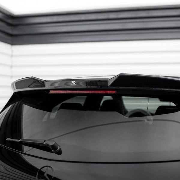 Car with rear spoiler, parked indoors; features a reflective black surface and rear wiper. A logo reading "MD" adorns the spoiler amidst horizontal white wall panels.