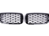 Two black, glossy car grilles feature a diamond-patterned mesh. They are positioned side by side against a plain white background, showcasing their shiny surface and symmetrical design.