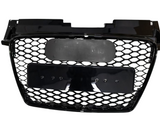 Black car grille with honeycomb-pattern mesh, mounted on a smooth rectangular frame, featuring two blank plates. The grille is isolated, displayed against a plain white background.