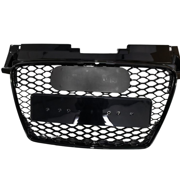 Black car grille with honeycomb-pattern mesh, mounted on a smooth rectangular frame, featuring two blank plates. The grille is isolated, displayed against a plain white background.