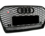 A hexagonal-patterned car grille displays the Audi logo and "RS6" on the top left. "quattro" is prominently indicated at the bottom against a black and silver honeycomb design.