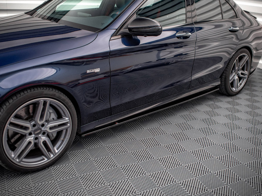 Car side view, parked in a garage with patterned flooring. The shiny, dark-colored vehicle displays "BITURBO" on the front side panel, highlighting a performance feature.