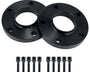 Two black wheel spacers rest on a white surface, each with five holes. In front, ten matching black bolts are neatly aligned, suggesting installation parts for automotive use.