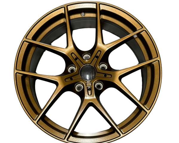 A metallic bronze alloy wheel with a multi-spoke design, displayed front-facing on a plain white background, showcasing its intricate style and smooth finish.