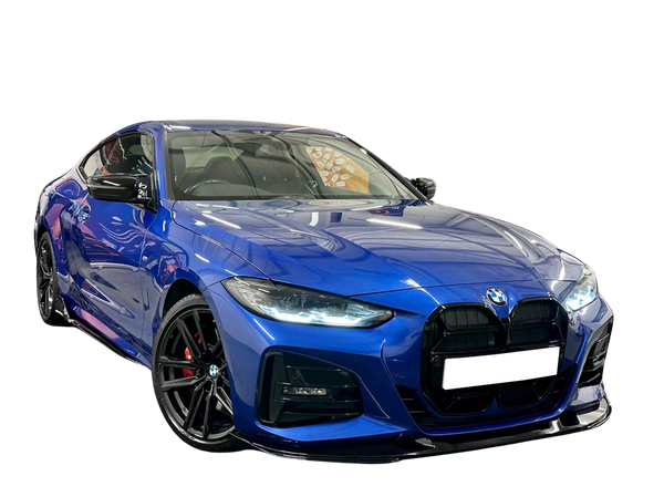 A sleek, blue BMW sports car is parked on a reflective surface, showcasing its prominent grille and polished alloy wheels against a plain black background.