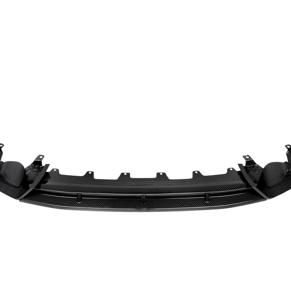 Curved black carbon fiber car bumper with mounting brackets, positioned horizontally against a plain white background, displaying a sleek design and intricate texture.