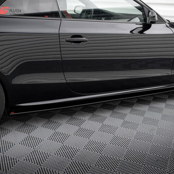 Car side with black body featuring red and black wheels, parked on a patterned floor; decals read "AUDI ELITE" and "mygermansports.com" on the window.