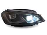 A car headlight brightly illuminates against a white background, showcasing its sleek design and clear lens, highlighting modern automotive lighting technology.