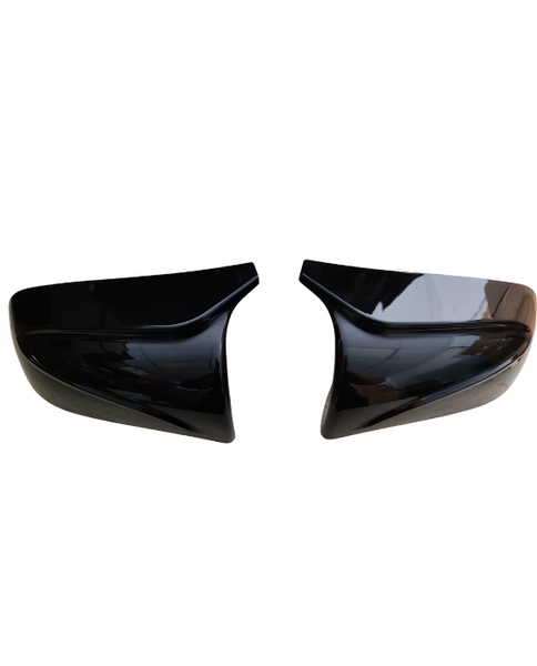Two black car mirror covers face each other, slightly tilted inward, against a plain white background.