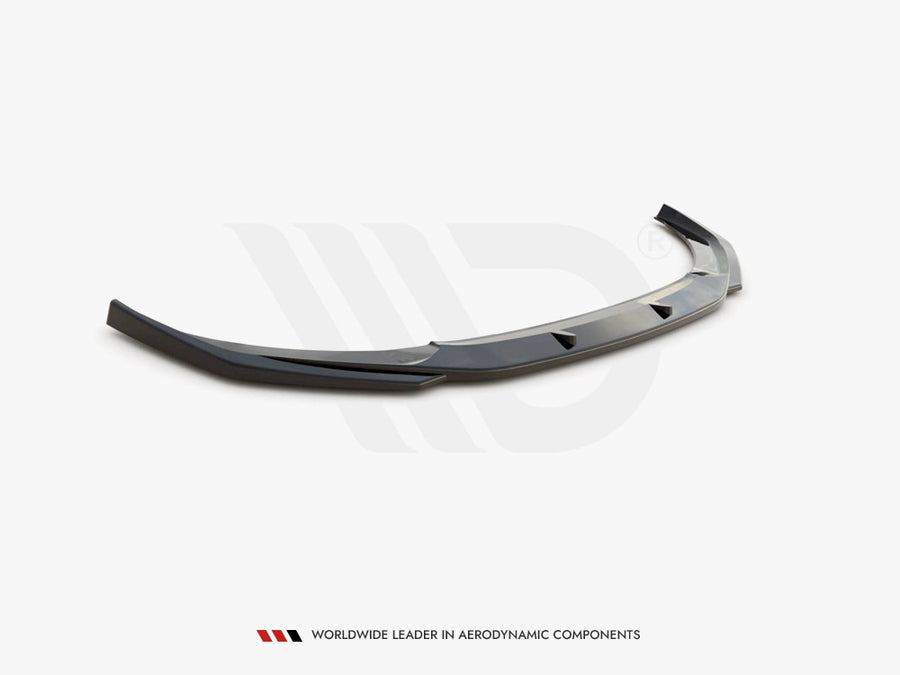 A sleek, dark gray car spoiler rests on a plain white surface, designed for aerodynamic enhancement. Text below reads: "WORLDWIDE LEADER IN AERODYNAMIC COMPONENTS."