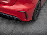 A red car's rear bumper and wheel are shown on a textured, gray, diamond-patterned mat, emphasizing sleek design and detailing.