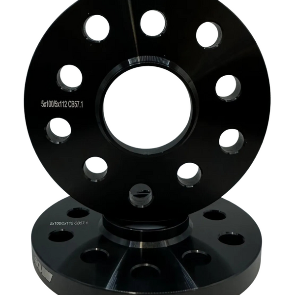 Two stacked black wheel spacers with multiple circular holes sit upright on a white background. Inscribed text reads: "5x100/5x112 CB57.1".