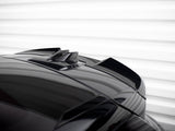A reflective black car roof features dual roof fins, set against a softly lit, horizontal white background, emphasizing sleek design and modernity.