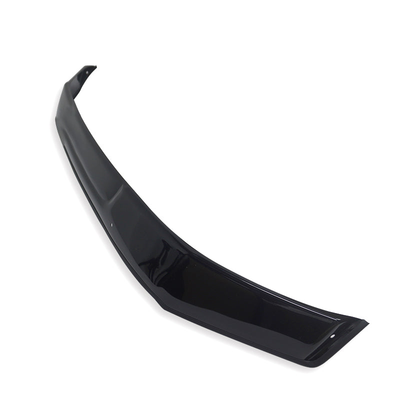 A glossy black car spoiler lies diagonally on a plain white background, showcasing its sleek, curved design and aerodynamic structure.