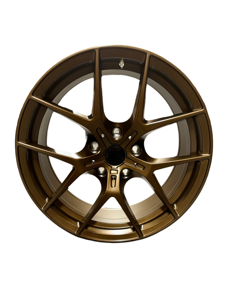 Bronze alloy wheel with a multi-spoke design, situated on a plain white background, featuring a central hub area for mounting. No text present.