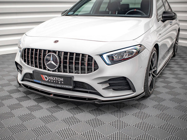 A white luxury car with a detailed front grille and distinctive headlights is parked in an indoor setting with patterned flooring. Logo text on plate reads: "MAXTON design."