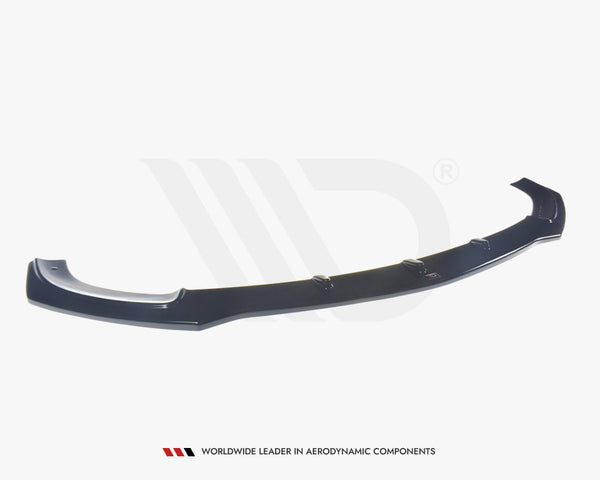 A black aerodynamic car component, resembling a front splitter, rests on a plain white background. Text below reads: "WORLDWIDE LEADER IN AERODYNAMIC COMPONENTS."