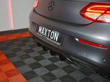 A rear view of a car with illuminated tail lights is parked on a checkered floor. The license plate reads 