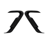 Two carbon fiber car door handles positioned symmetrically, facing each other against a white background, showcasing their sleek, contoured design and smooth texture.