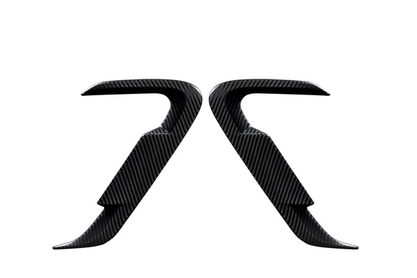 Two carbon fiber car door handles positioned symmetrically, facing each other against a white background, showcasing their sleek, contoured design and smooth texture.