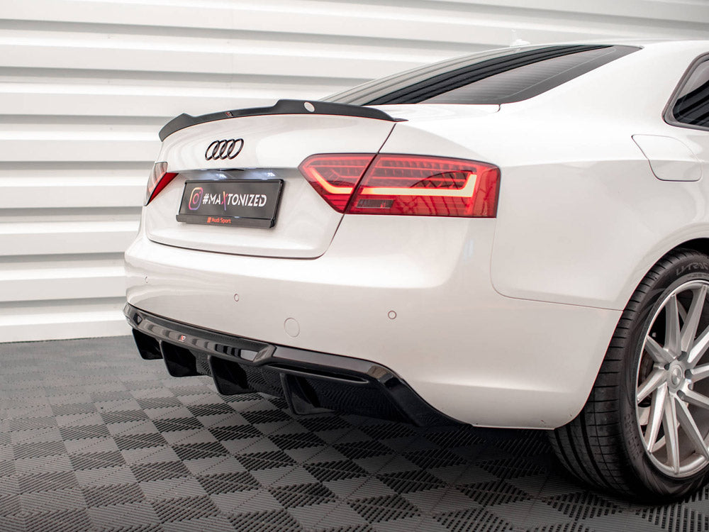 Car with sleek rear design, featuring tinted taillights and dual exhaust, parked on patterned floor. License plate reads "#MAXTONIZED @Maxton Design." White wall paneling provides a modern backdrop.