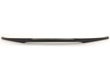 A long, sleek, black object, possibly an automotive accessory or trim piece, lies horizontally against a plain white background.