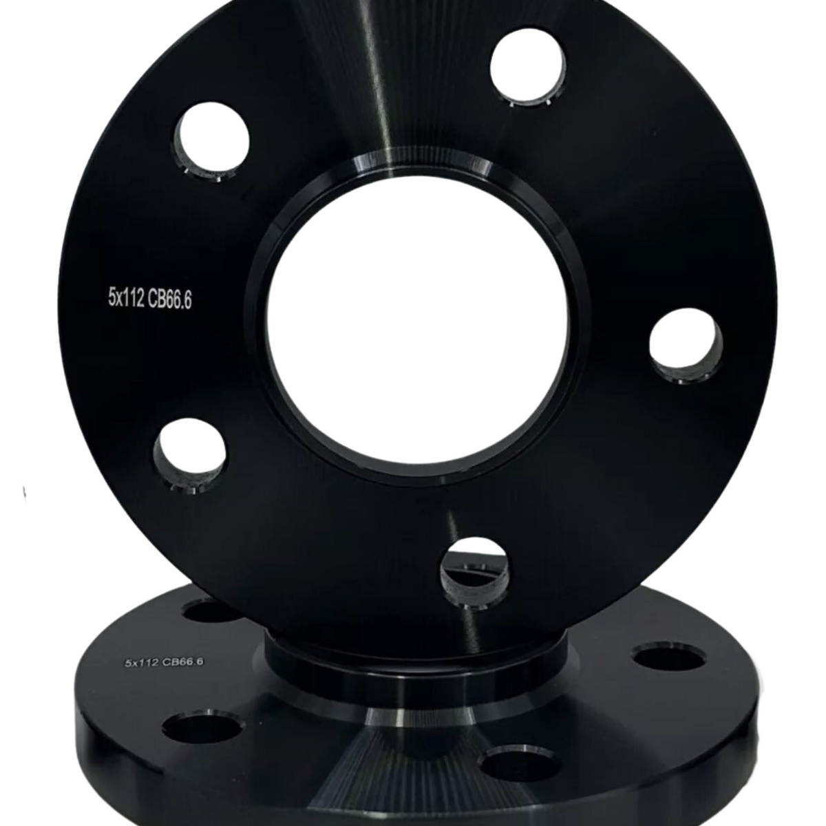 A black metal wheel spacer with multiple holes sits on a matching base, displaying the text "5x112 CB66.6."