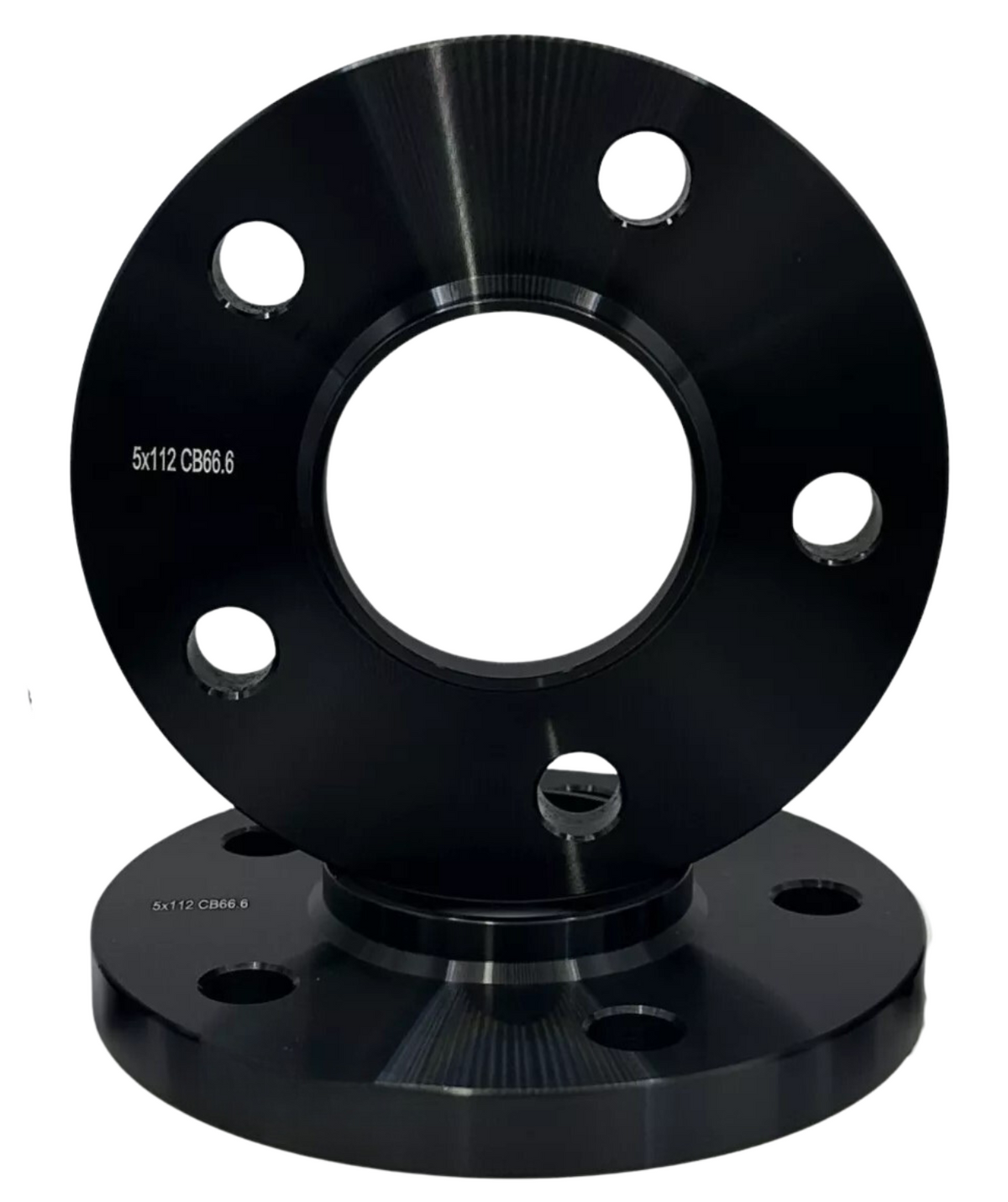 A black metal wheel spacer with multiple holes sits on a matching base, displaying the text "5x112 CB66.6."