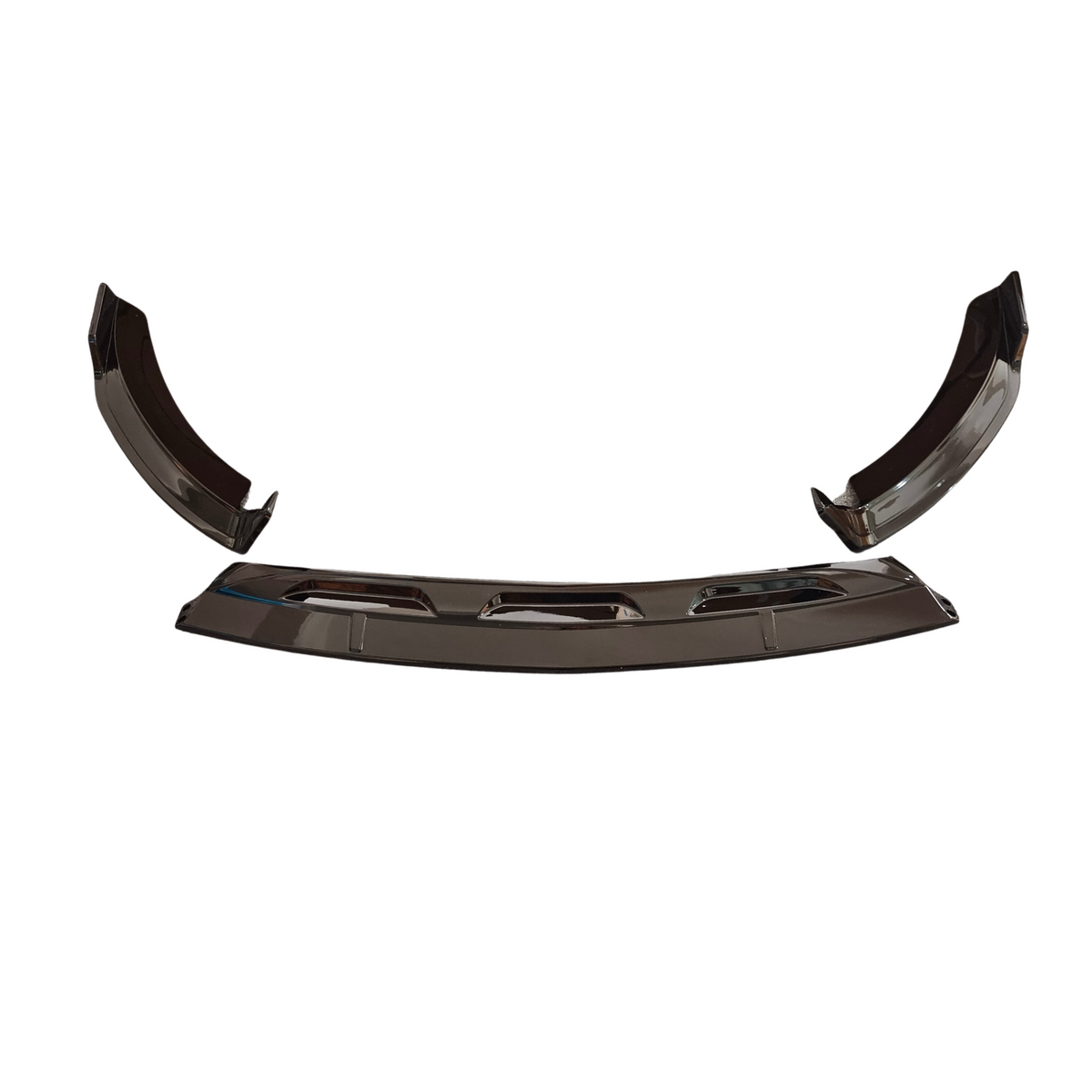 Curved metallic car parts, likely bumper elements, resting on a plain white background, showcasing reflective surfaces and angular edges.