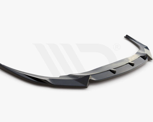 A sleek, black aerodynamic car spoiler is shown, extending horizontally with angled edges. It rests on a plain white background. Text reads: "WORLDWIDE LEADER IN AERODYNAMIC COMPONENTS."