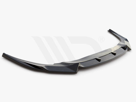 A sleek, black aerodynamic car spoiler is shown, extending horizontally with angled edges. It rests on a plain white background. Text reads: "WORLDWIDE LEADER IN AERODYNAMIC COMPONENTS."