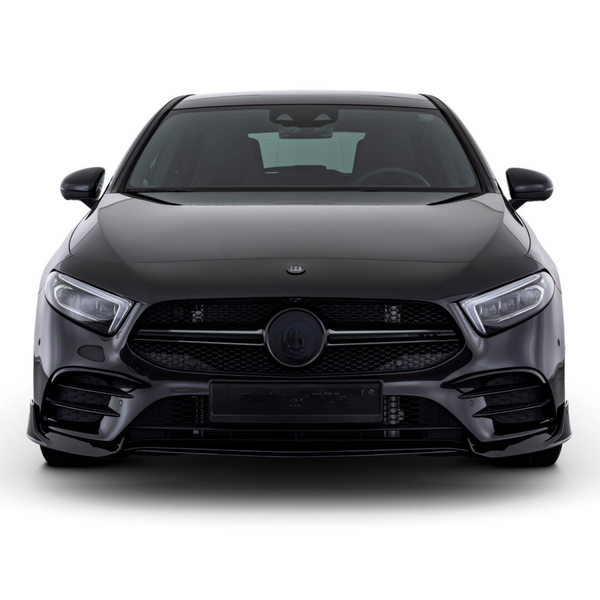 A sleek, black car is stationary, facing forward, showcasing its bold grille and headlights in a studio setting.