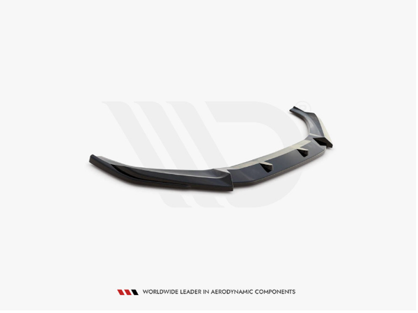 Black car bumper lip sits angled on a white surface. Below, text reads: "WORLDWIDE LEADER IN AERODYNAMIC COMPONENTS."