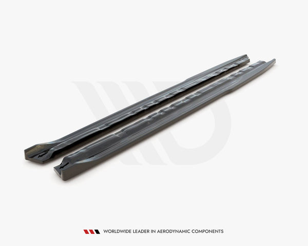 Two long, sleek car components are placed parallel on a plain surface. The text reads, "WORLDWIDE LEADER IN AERODYNAMIC COMPONENTS."
