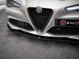 Car front with Alfa Romeo badge and honeycomb grille, parked on a patterned floor. License plate displays 