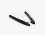 Two sleek, black aerodynamic components resting on a white background. They are angled and streamlined in design. Text at the bottom reads: 