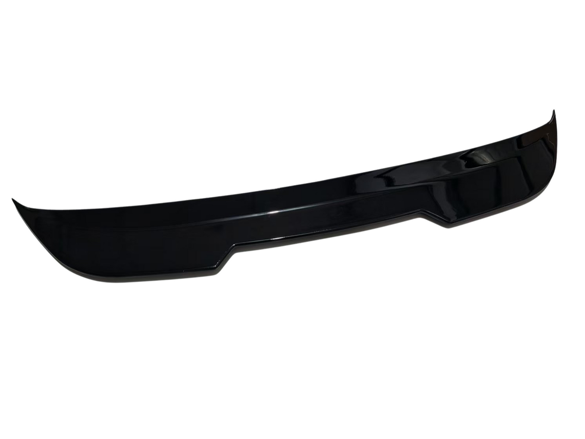 A black car spoiler with a sleek, curved design rests on a plain white background, highlighting its glossy finish and aerodynamic shape.