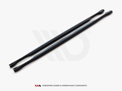 Two long, black, aerodynamic bars lie parallel on a white surface. A logo is subtly visible behind them. Text below reads: "WORLDWIDE LEADER IN AERODYNAMIC COMPONENTS."