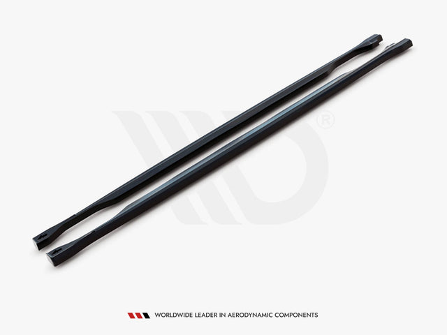 Two long, black, aerodynamic bars lie parallel on a white surface. A logo is subtly visible behind them. Text below reads: "WORLDWIDE LEADER IN AERODYNAMIC COMPONENTS."