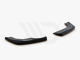 Two black aerodynamic components, angled and glossy, rest on a plain white surface. Text: 