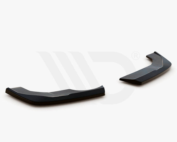 Two black aerodynamic components, angled and glossy, rest on a plain white surface. Text: "WORLDWIDE LEADER IN AERODYNAMIC COMPONENTS" appears below.