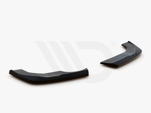 Two black aerodynamic components, angled and glossy, rest on a plain white surface. Text: "WORLDWIDE LEADER IN AERODYNAMIC COMPONENTS" appears below.