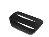 A black, carbon fiber vent with a slatted design, positioned diagonally against a plain white background, showcasing its reflective texture and sleek, aerodynamic appearance.