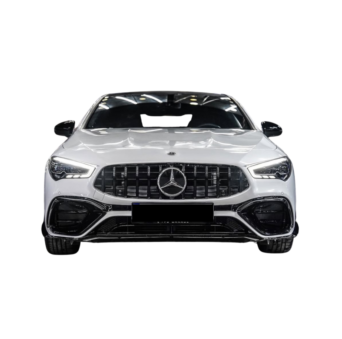 A white Mercedes-Benz car is displayed from the front, showcasing a prominent grille, sleek headlights, and a glossy finish in an isolated setting.